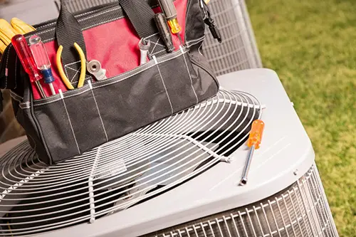 HVAC maintenance tools on top of outdoor AC unit for Greenway Home Services in Tennessee